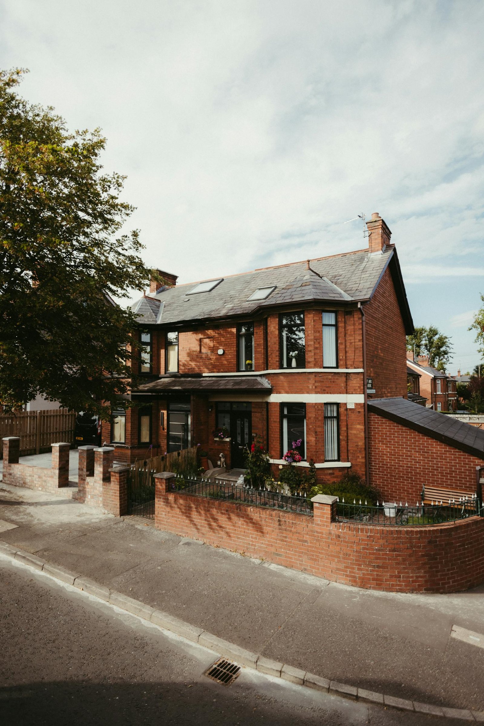 A beautiful red brick house located in a quiet neighborhood in Belfast, Northern Ireland, showcasing classic architecture.